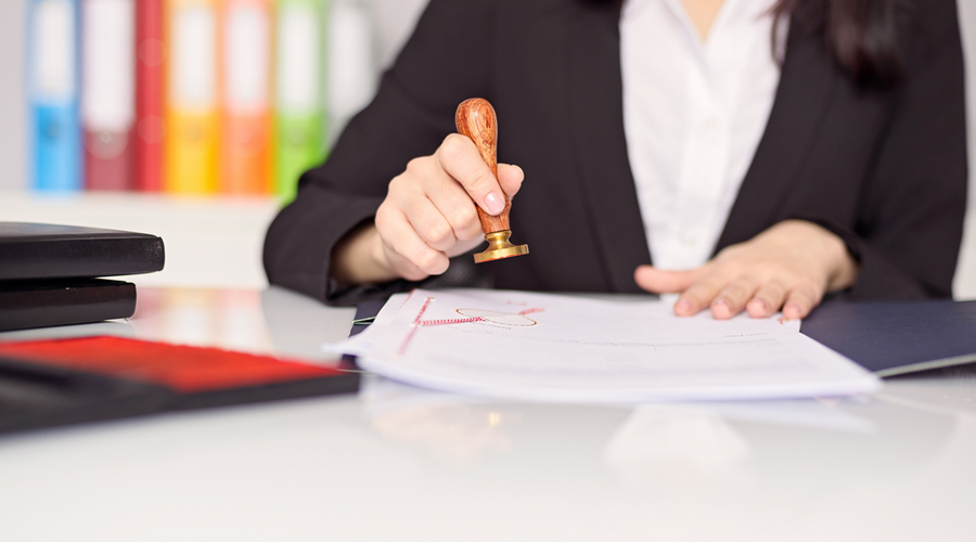 A woman stamping a certificate document