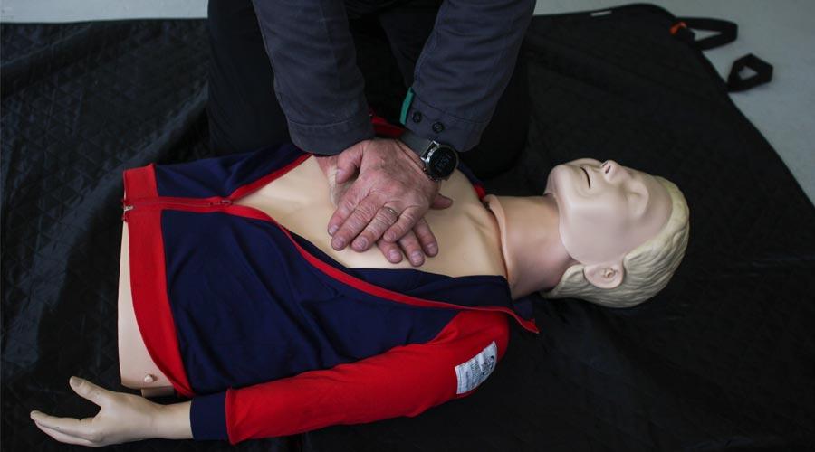 uomo che esegue il primo soccorso su un manichino